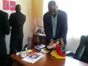 Pastor Evan Mawarire in handcuffs as police search his home