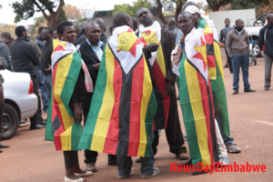 Supporters outside the Harare Magistrate's Court wear the national flag / Photo Credit: NewsDay