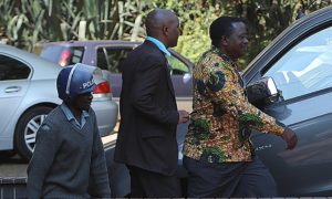Zimbabwe war veterans’ association secretary general Victor Matemadanda, right, is escorted by police to a court hearing. / Photo Credit: Wilfred Kajese/AFP/Getty Images